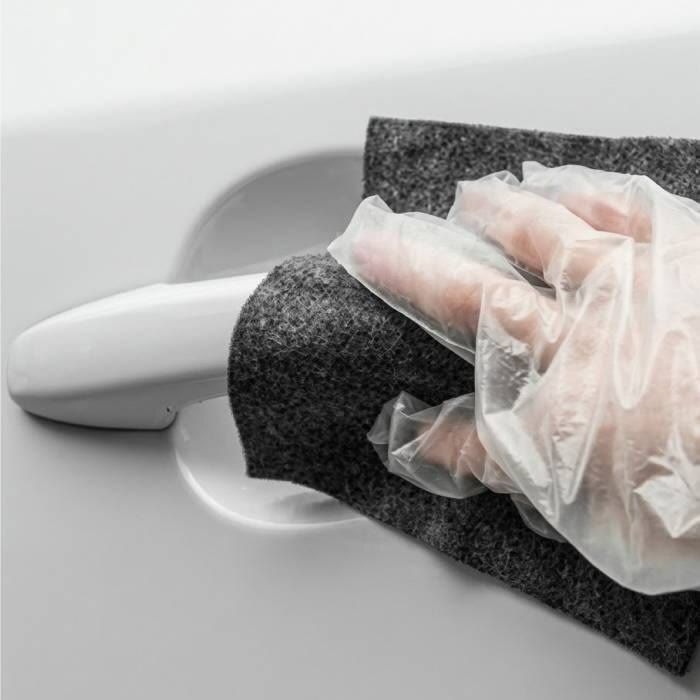 The seller's photo: a gloved hand rubbing the cloth over the marks