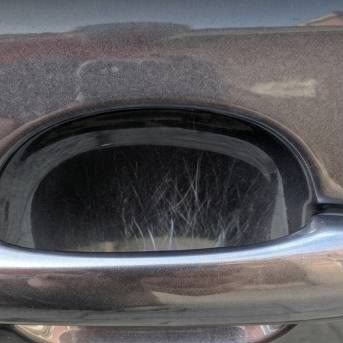 The seller's photo: fine scratches around a door handle