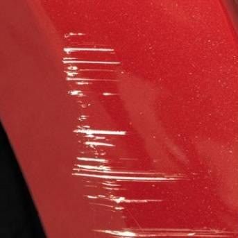 The seller's photo: light scuffs on red paint