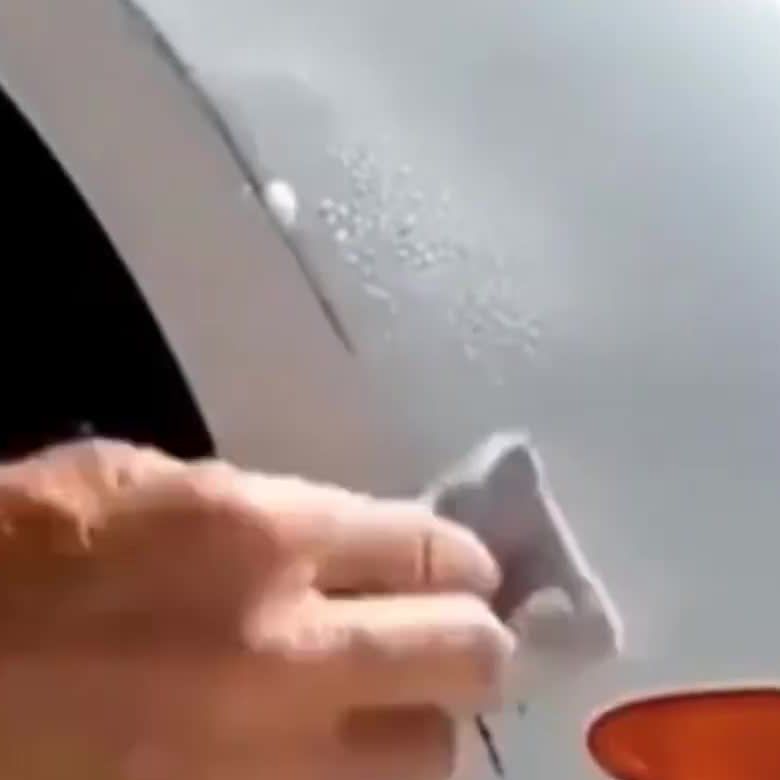 The seller's photo: a paint transfer scuff on a white car
